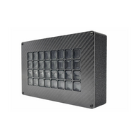 Carbon fiber panel with embedded square components on a white background