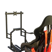 A black monitor mount attached to a racing simulating chair with red and orange safety straps.