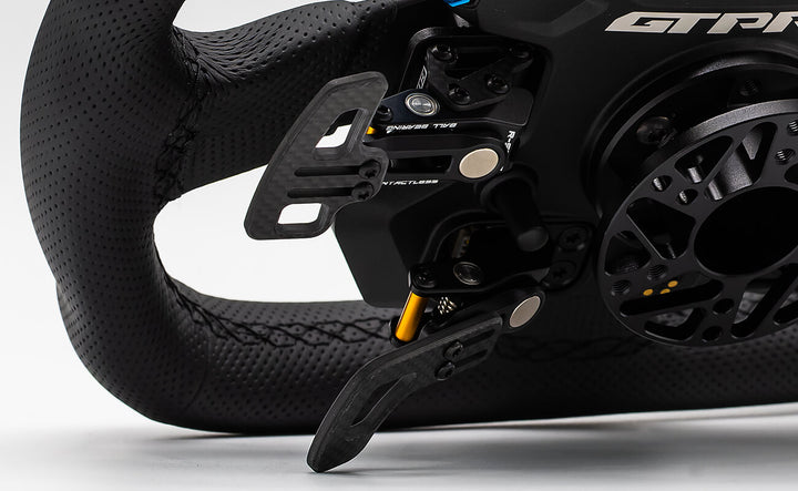 Close-up of a racing wheel with a brand logo on a white background