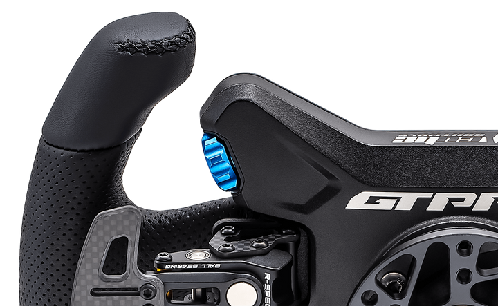 Close-up of a black steering wheel with 'GTR' branding on a white background